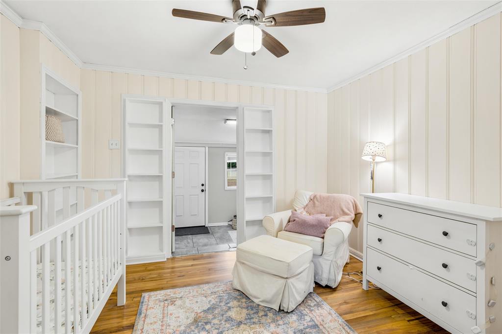 3012 Mitchell Avenue Waco, TX 76708 - Photo 9 of 18 Room featuring wood-finish flooring, vertical paneling, and a ceiling fan with integrated lighting