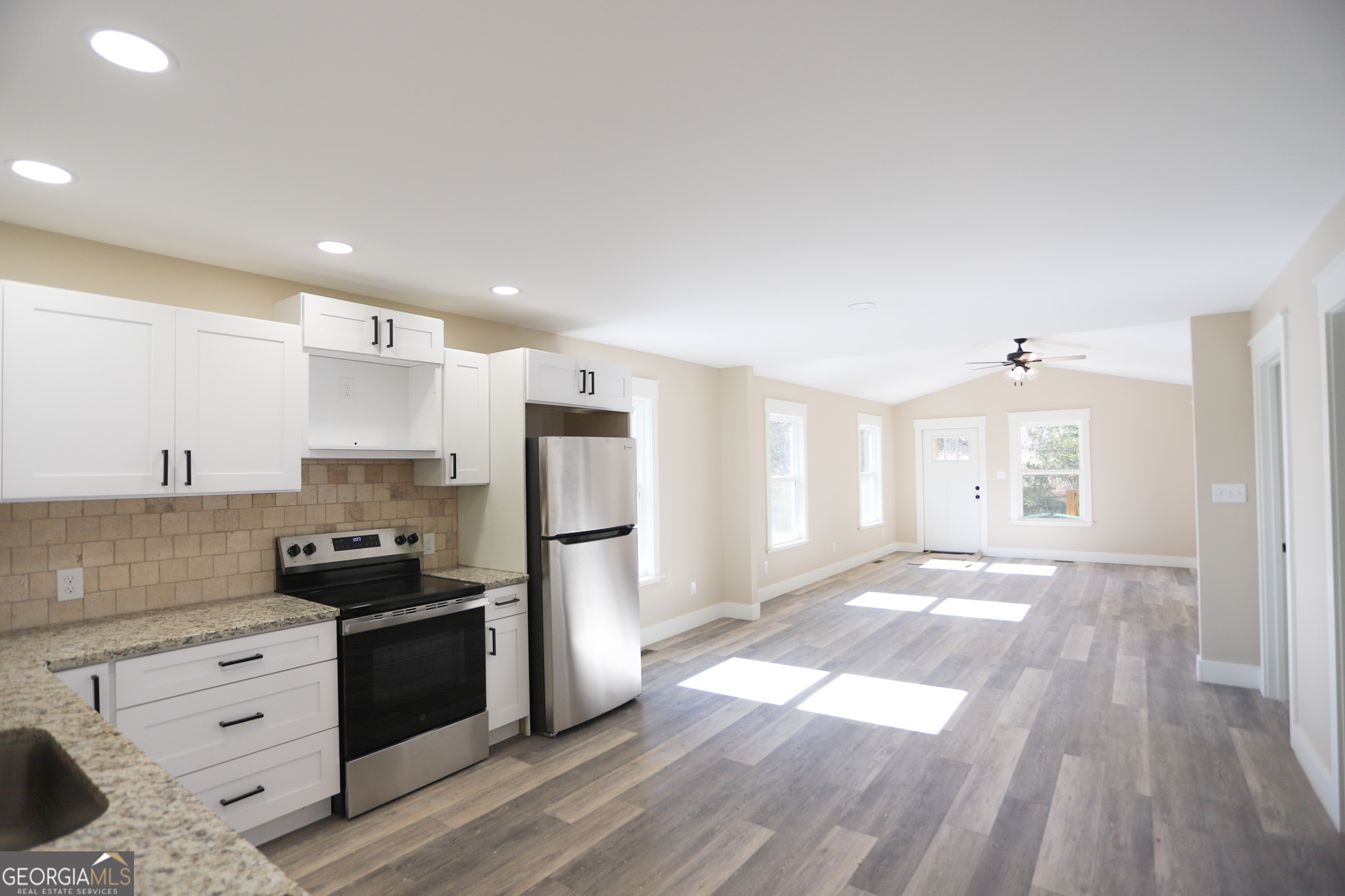 96 Orchard Road Summerville, GA 30747 - Photo 12 of 23 a kitchen with granite countertop a refrigerator stove top oven and sink