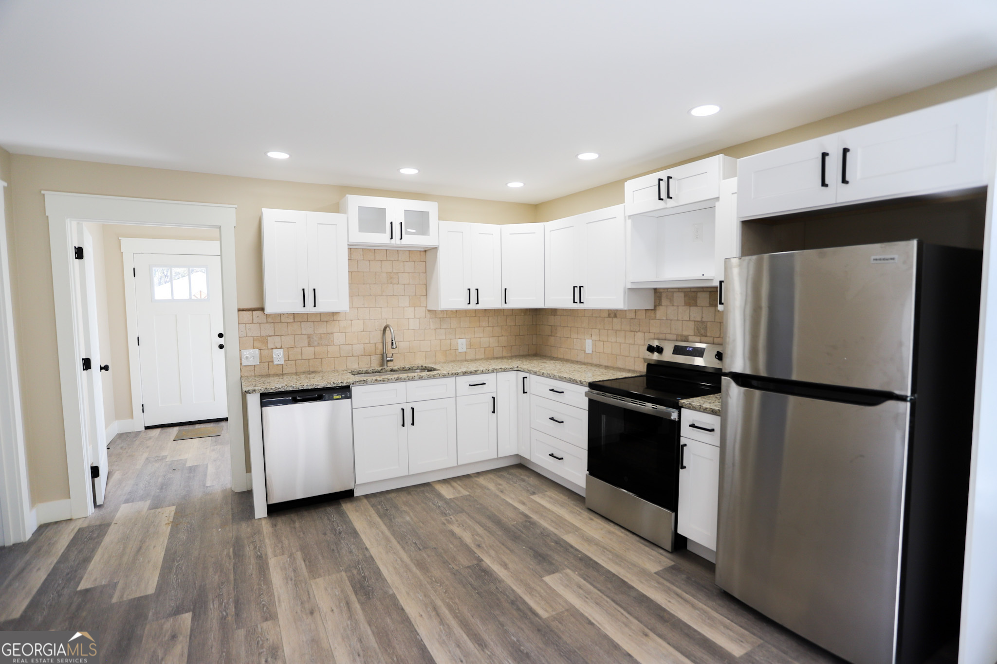 96 Orchard Road Summerville, GA 30747 - Photo 14 of 23 a kitchen with a refrigerator a sink and white cabinets