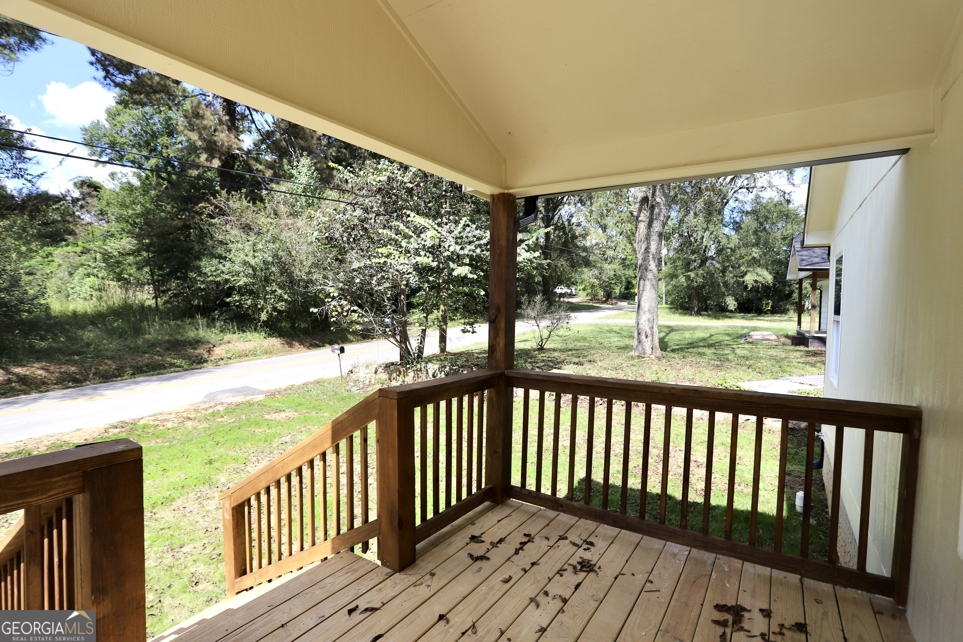 96 Orchard Road Summerville, GA 30747 - Photo 4 of 23 a view of a wooden deck next to a yard with wooden fence