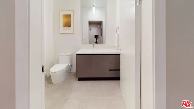 a room with a sink and a mirror
