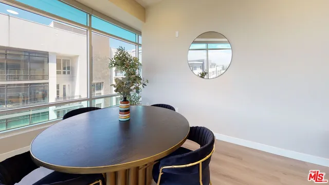 a view of a dining room with furniture and window