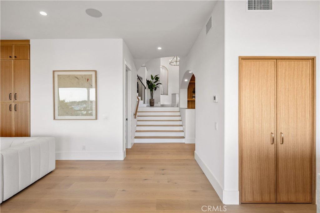2915 Cliff Drive Newport Beach, CA 92663 - Photo 32 of 69 a view of a hallway to a bedroom with wooden floor and windows
