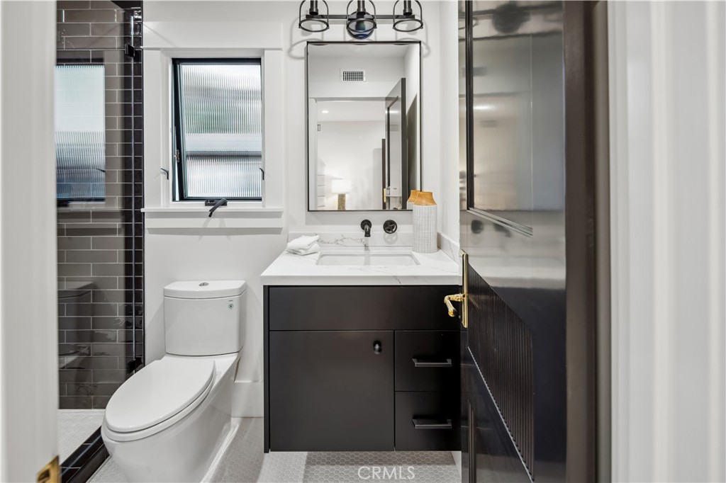 2915 Cliff Drive Newport Beach, CA 92663 - Photo 60 of 69 a bathroom with a sink vanity mirror and toilet