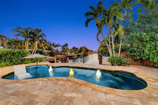 a view of swimming pool with outdoor seating and plants