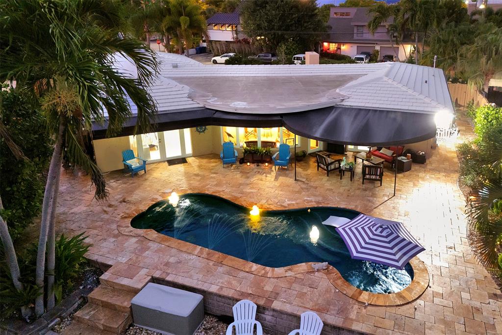 1500 Northeast 24th Street Wilton Manors, FL 33305 - Photo 11 of 88 an aerial view of a house with a swimming pool patio and outdoor seating
