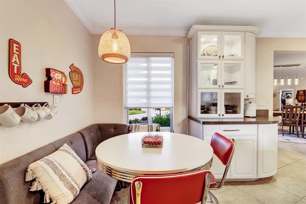 1500 Northeast 24th Street Wilton Manors, FL 33305 - Photo 33 of 88 a living room with dining table and chairs