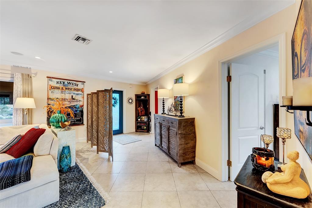 1500 Northeast 24th Street Wilton Manors, FL 33305 - Photo 42 of 88 a living room with furniture a flat screen tv and a refrigerator