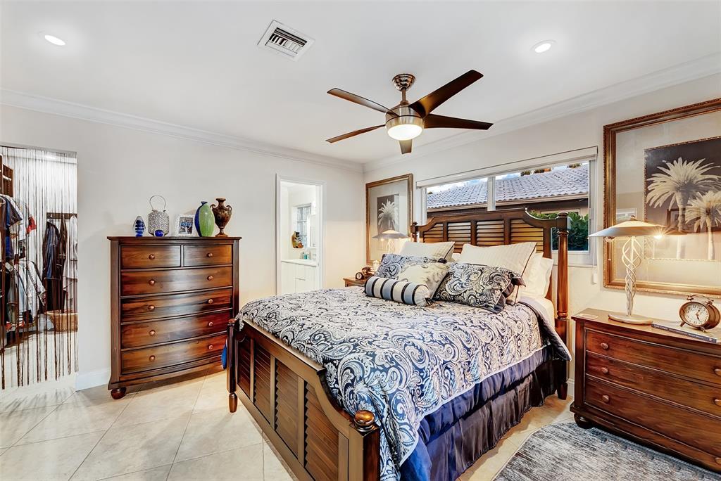 1500 Northeast 24th Street Wilton Manors, FL 33305 - Photo 47 of 88 a bedroom with a bed and a chandelier