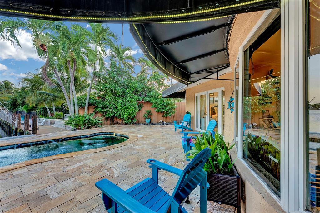 1500 Northeast 24th Street Wilton Manors, FL 33305 - Photo 52 of 88 a backyard of a house with fountain table and chairs