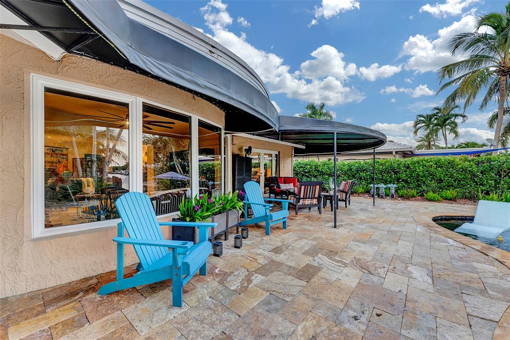 1500 Northeast 24th Street Wilton Manors, FL 33305 - Photo 62 of 88 a view of a patio with a table and chairs and potted plants