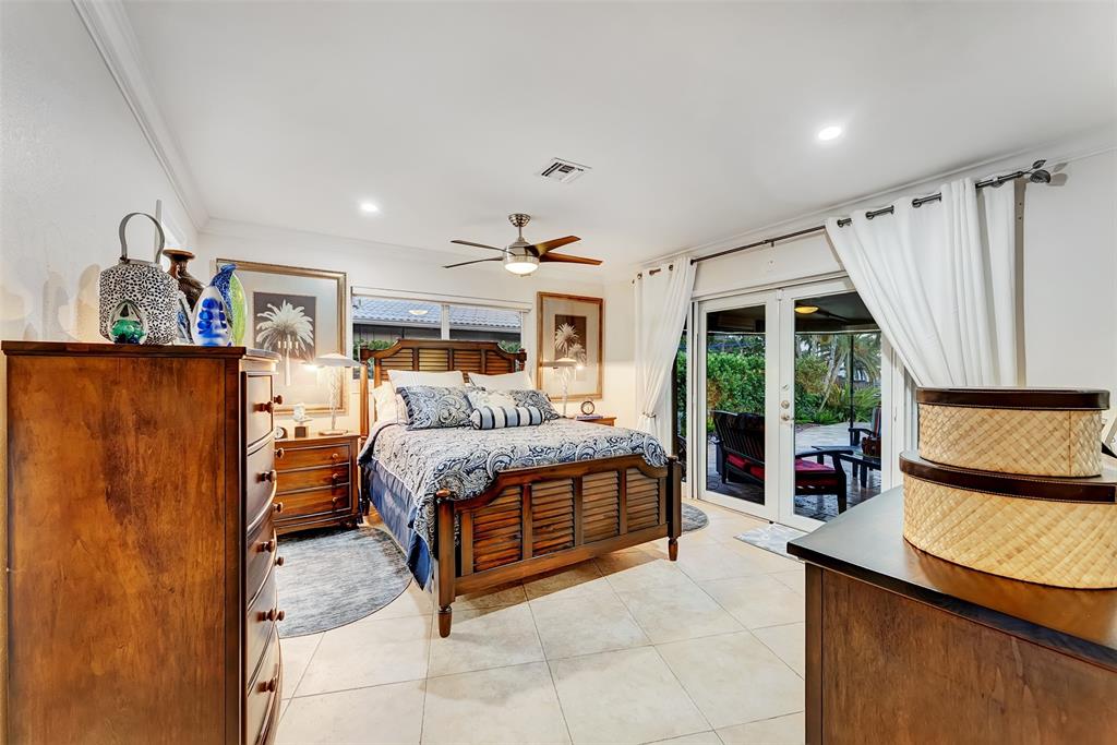 1500 Northeast 24th Street Wilton Manors, FL 33305 - Photo 73 of 88 a bedroom with a bed and a large window