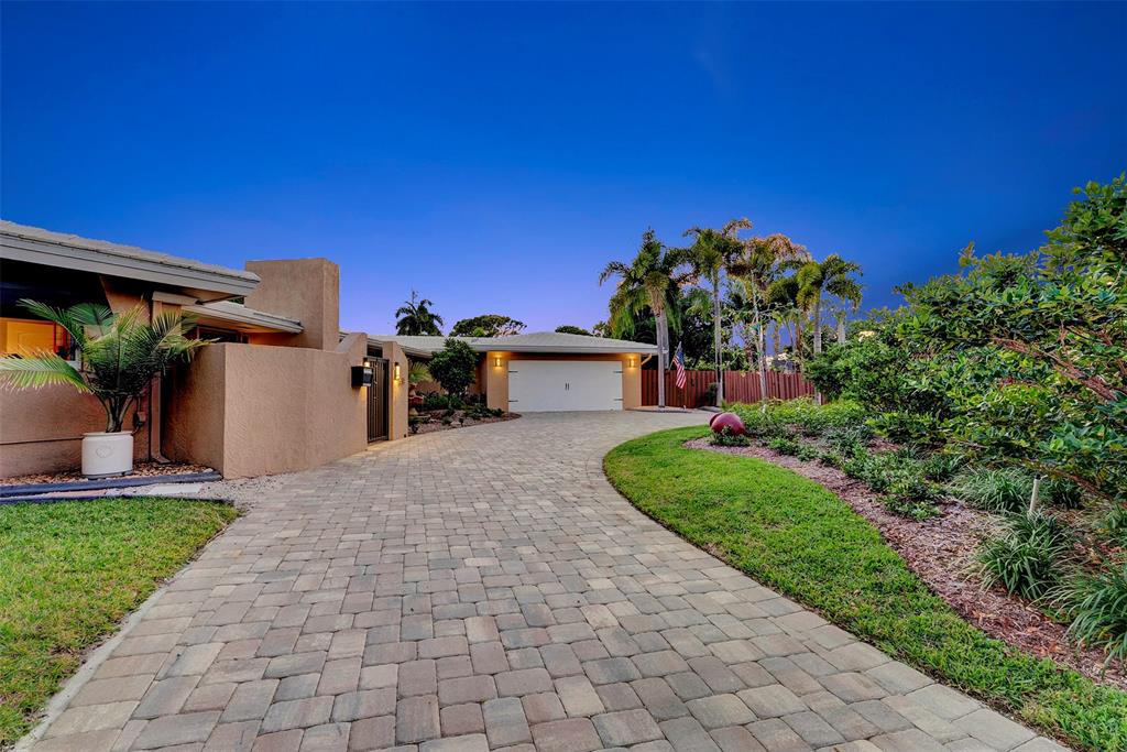 1500 Northeast 24th Street Wilton Manors, FL 33305 - Photo 78 of 88 a front view of a house with a yard and garage