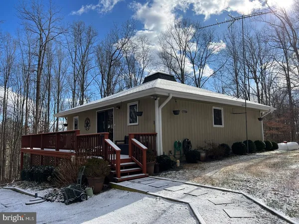 a view of a house with a patio and a yard