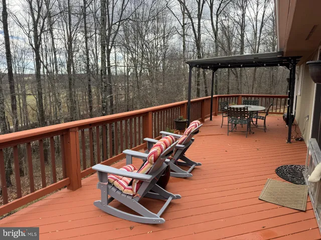 a view of balcony with chairs and wooden fence