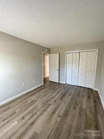 a view of an empty room and wooden floor