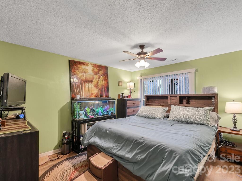 19 Krista Circle, Unit E Candler, NC 28715 - Photo 12 of 23 a bedroom with a bed and a flat screen tv