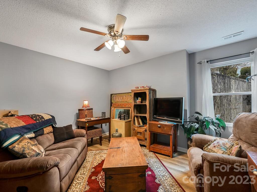 19 Krista Circle, Unit E Candler, NC 28715 - Photo 14 of 23 a living room with furniture a flat screen tv and a window