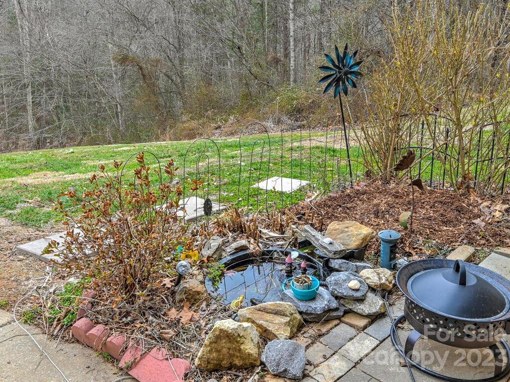 19 Krista Circle, Unit E Candler, NC 28715 - Photo 18 of 23 a backyard of a house with lots of green space and glass windows
