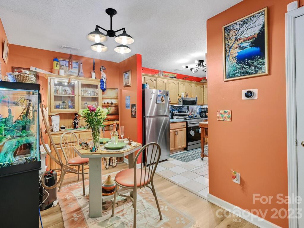 19 Krista Circle, Unit E Candler, NC 28715 - Photo 6 of 23 a view of a dining room with furniture and chandelier