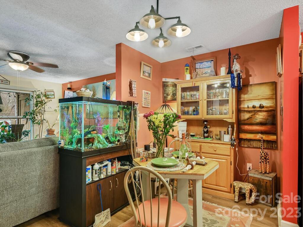 19 Krista Circle, Unit E Candler, NC 28715 - Photo 7 of 23 a view of a dining room with furniture a kitchen and chandelier