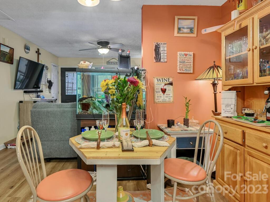 19 Krista Circle, Unit E Candler, NC 28715 - Photo 8 of 23 a dining room with furniture a window and a flat screen tv
