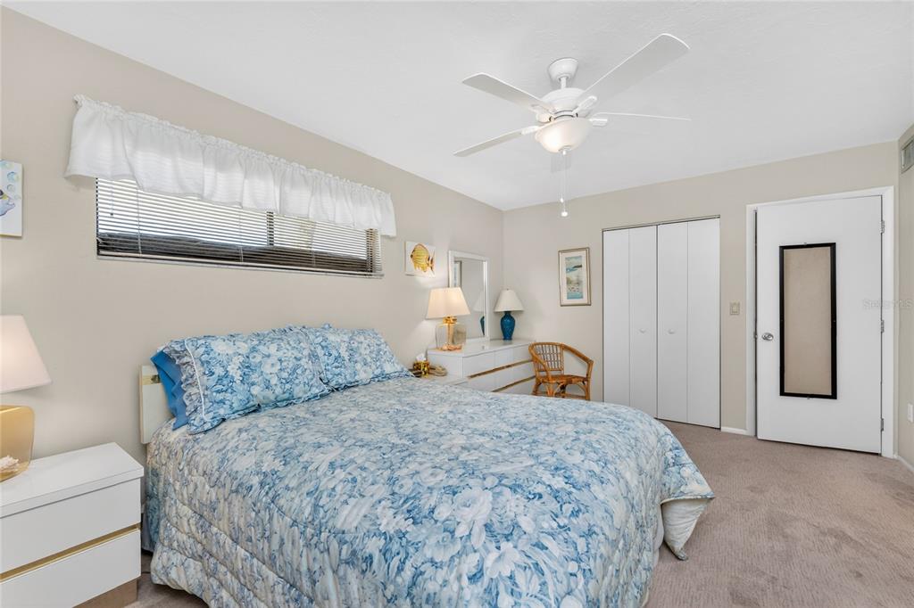 2955 North Beach Road, Unit B614 Englewood, FL 34223 - Photo 25 of 67 a bedroom with a large bed and a chandelier