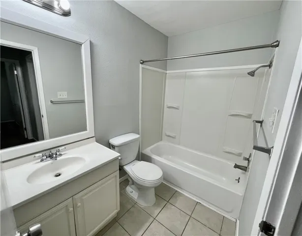 a bathroom with a sink a toilet a mirror a vanity and shower