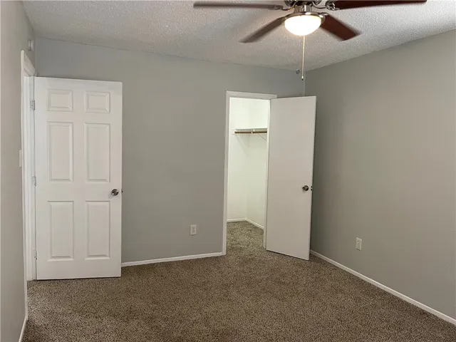 an empty room with a ceiling fan