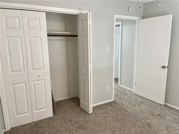 an empty room with closet area