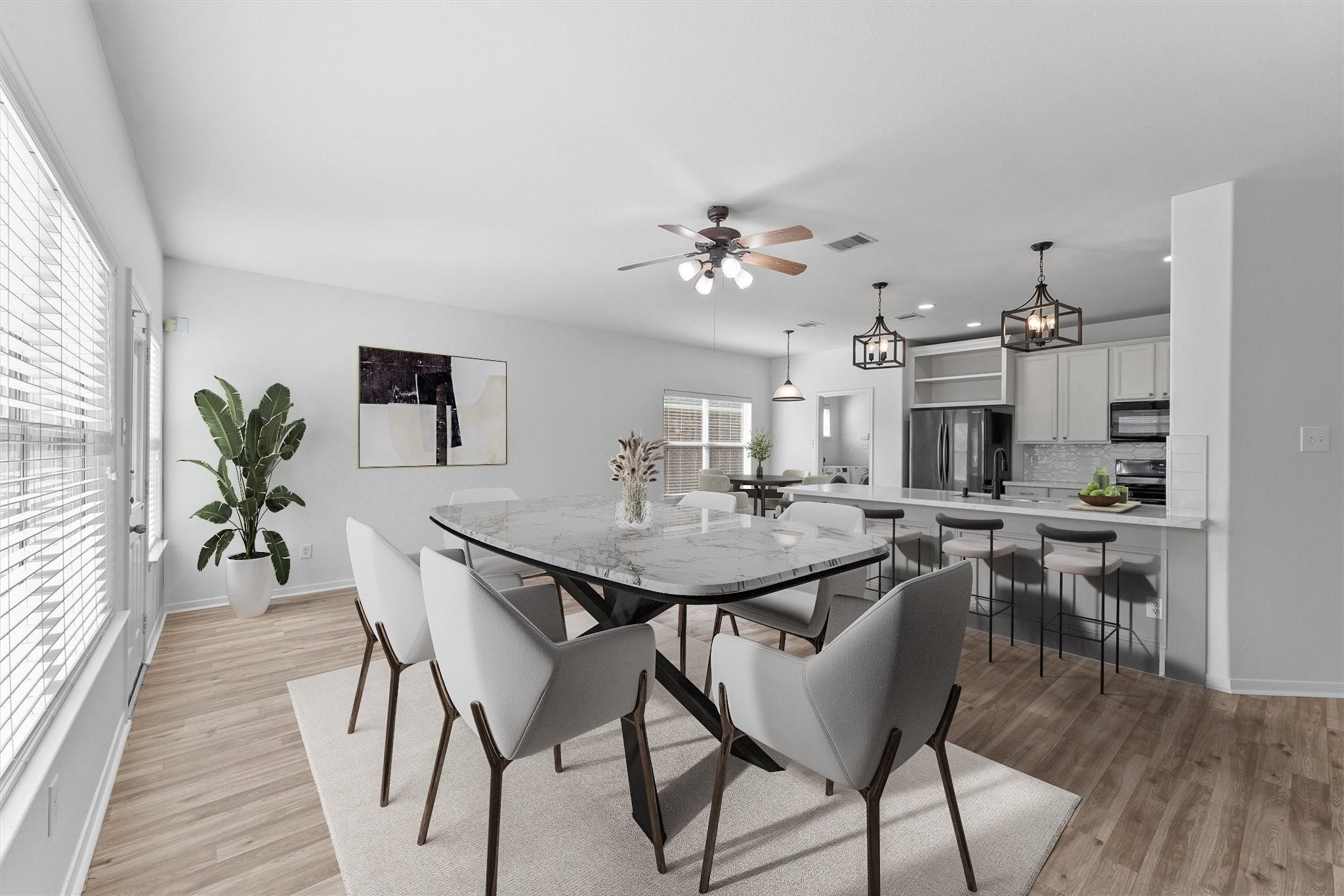 a view of a dining room with furniture and wooden floor
