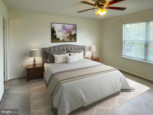 a bedroom with a bed and a painting on the wall