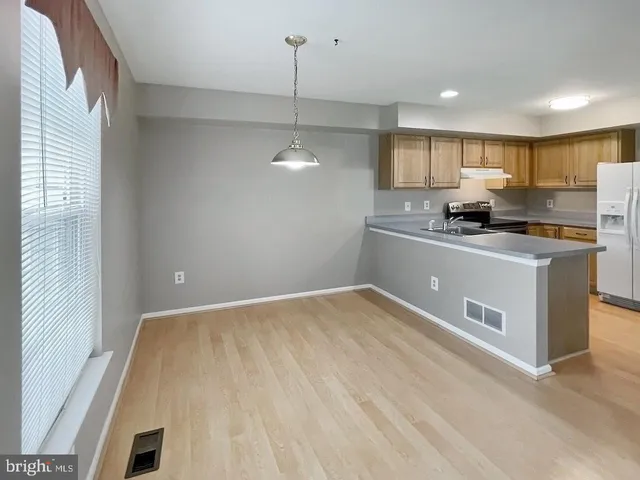 a kitchen with kitchen island a sink appliances and cabinets