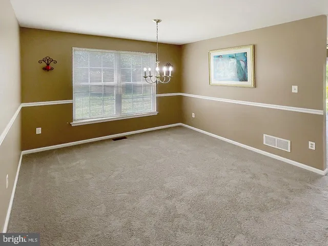 an empty room with windows and cabinet