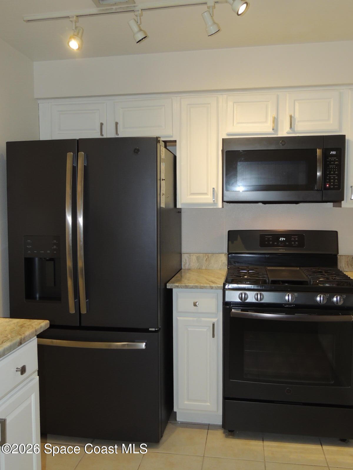 1312 Huntington Lane Rockledge, FL 32955 - Photo 5 of 21 a kitchen with a refrigerator and stove