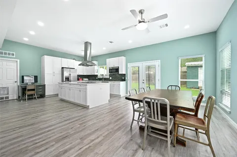 a view of a dining room with furniture and wooden floor