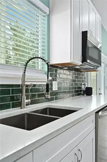 a kitchen with a sink and a microwave