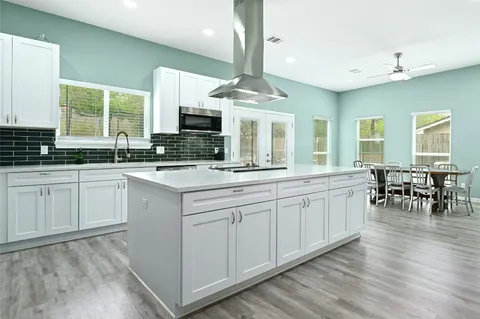 a kitchen with stainless steel appliances granite countertop a sink and cabinets