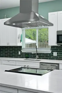 a kitchen with a stove and a white cabinet