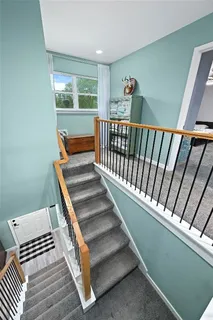 a view of entryway and hall with wooden floor