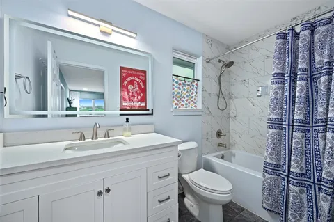 a bathroom with a toilet sink and shower