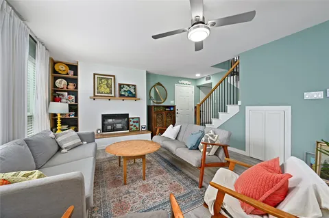 a living room with furniture fireplace and a window