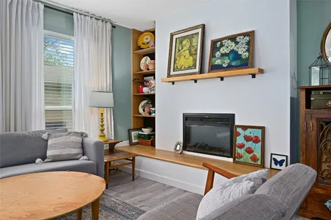 a living room with furniture fireplace and a window