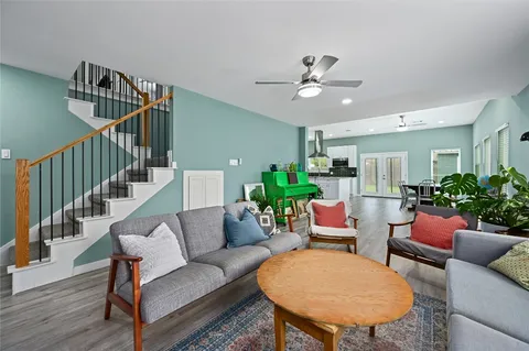a living room with furniture and a potted plant