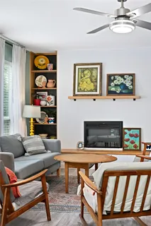 a living room with furniture and a fireplace