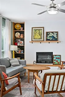 a living room with furniture and a fireplace