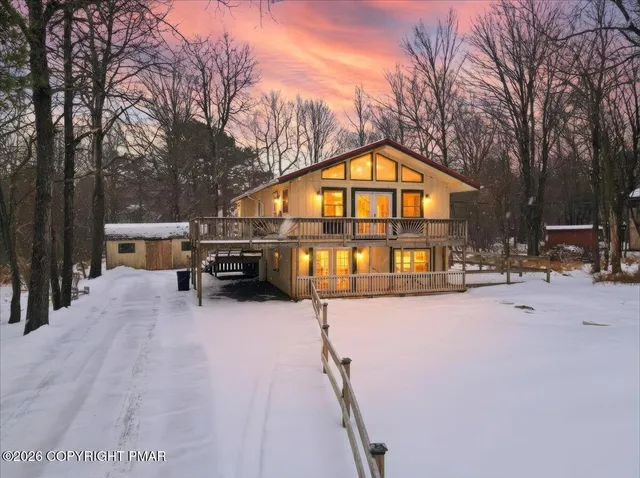 a view of a house with snow on the road