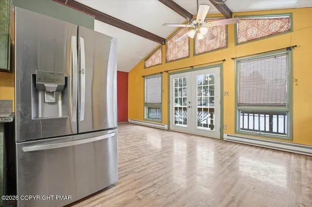 a view of an empty room with wooden floor