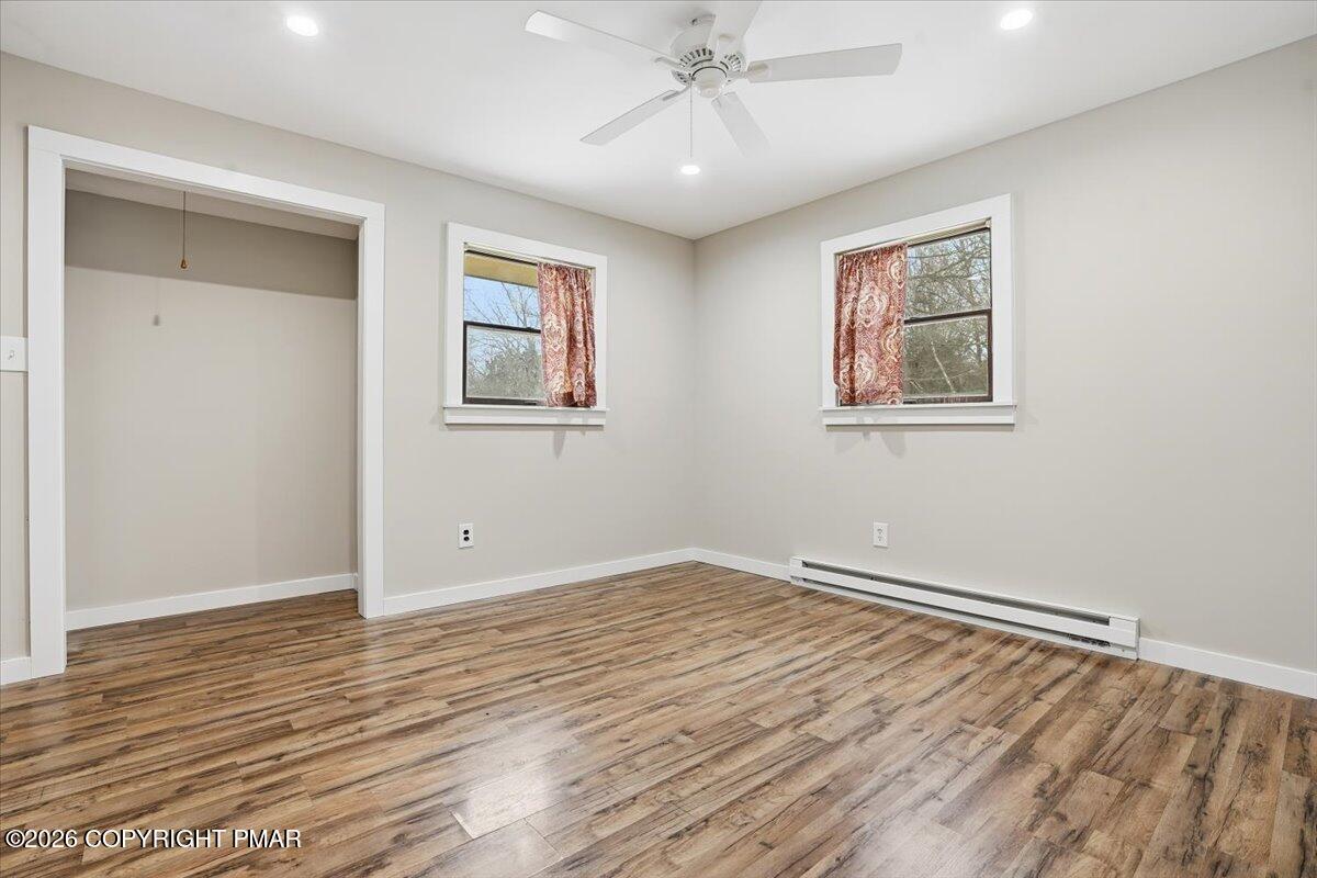 401 Clearview Drive Long Pond, PA 18334 - Photo 27 of 77 a view of an empty room with wooden floor and a ceiling fan