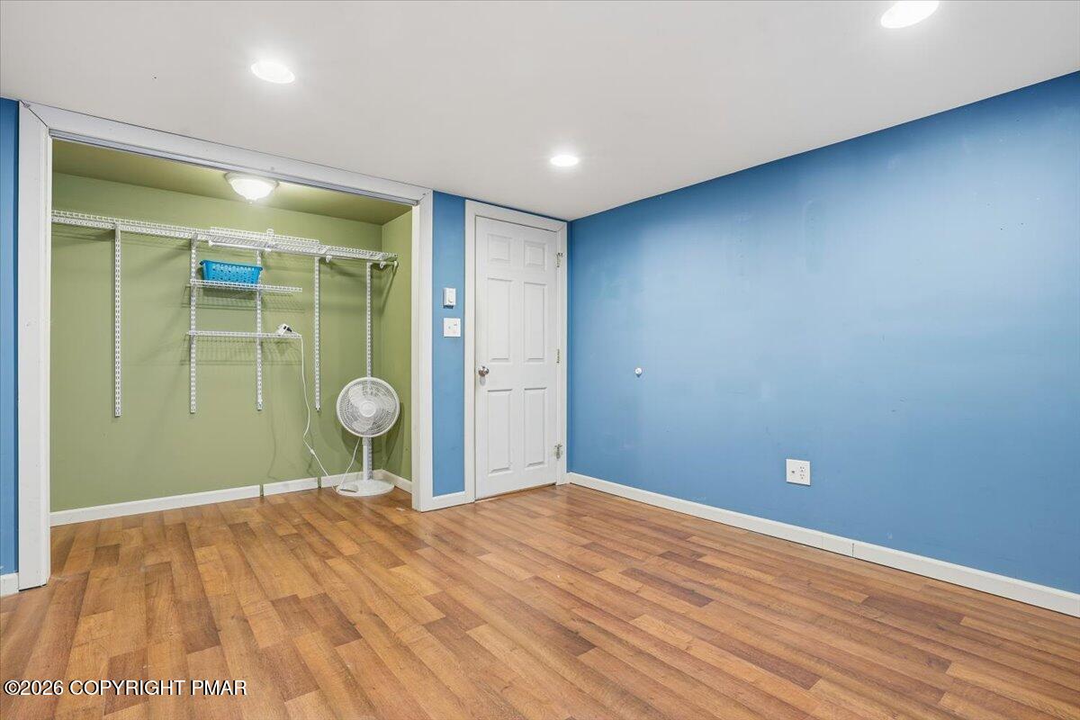 401 Clearview Drive Long Pond, PA 18334 - Photo 40 of 77 a view of a room with wooden floor and mirror